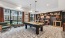 a clubhouse room with a pool table and chairs