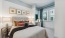 a bedroom with a bed and a table