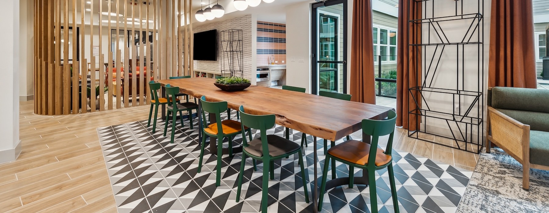 a clubhouse room with a table and chairs