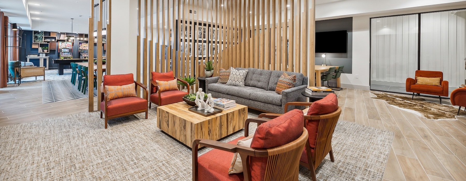 a clubhouse room with chairs a coffee table and a couch