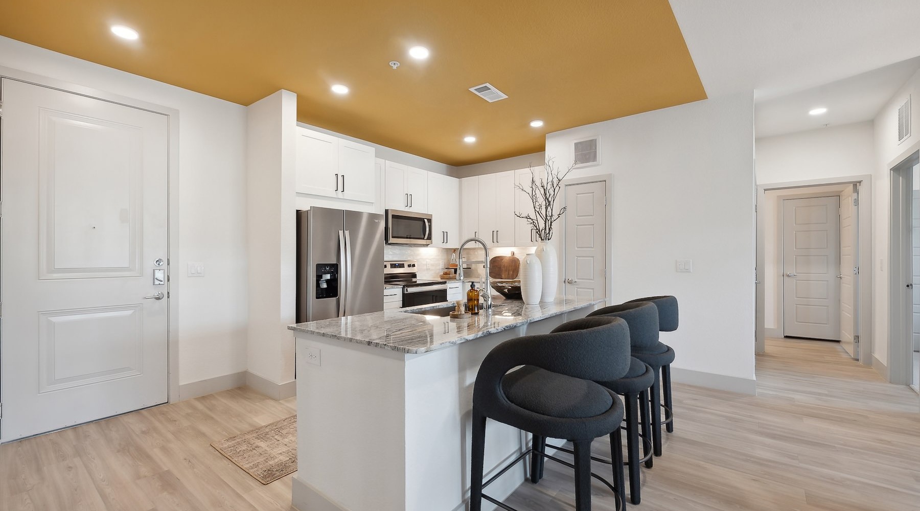 a kitchen with a large island and bar stools