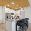 a kitchen with a large island and bar stools