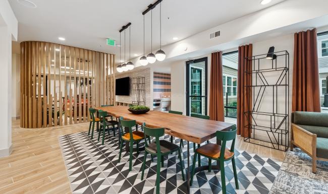 a clubhouse room with a table and chairs